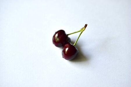 Fruits of ripe red and delicious cherries on a white backgroundの写真素材