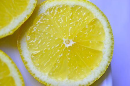 Cut the slices of ripe yellow lemons with sugarの写真素材