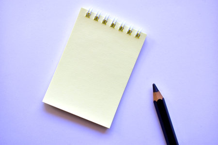 Black large pencil and Notepad on a white background