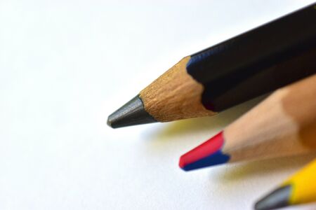 Multi-colored and large pencils on a white backgroundの写真素材