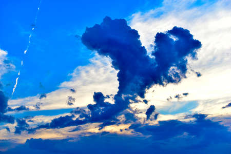 Blue skies and the trace of a passing planeの写真素材