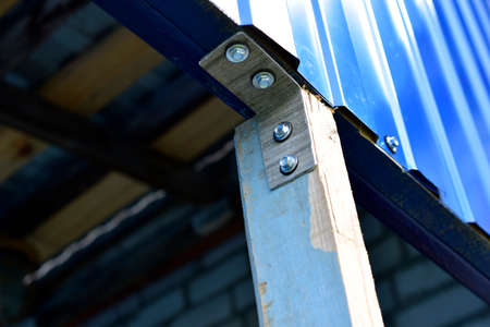 Fasteners of a wooden structure with the help of an iron corner and self-tapping screwsの写真素材