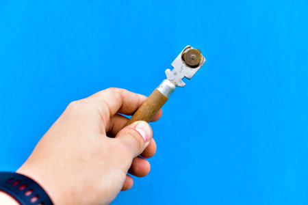 Special blade on the glass in the hand on a blue background