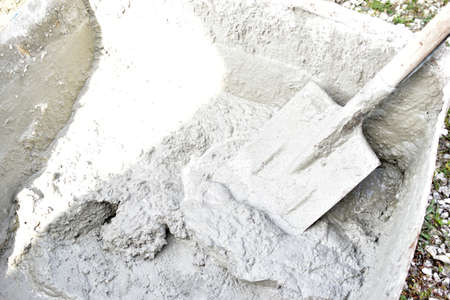 Mixing cement in the muld with shovels for constructionの写真素材