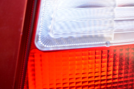 Rear red and white car glass lights close up