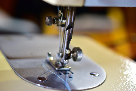 Sewing machine and work surface with needle and thread