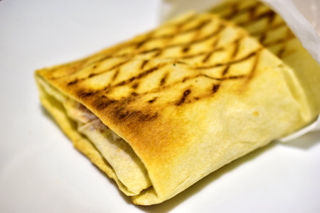 One delicious Shawarma on a plate in the evening