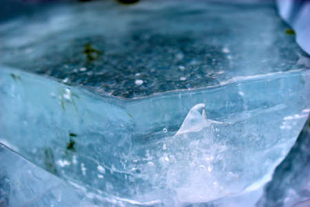 Blue blocks of ice close up with bubbles and cracksの写真素材
