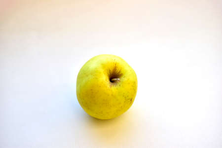 Yellow green apple on a white background close upの写真素材