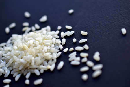 Crumbled white rice on a black backgroundの写真素材