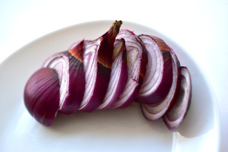 Sliced blue onion on a white plate close-up