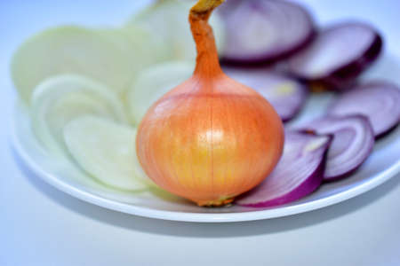 Blue and yellow onion cut into round pieces with a whole onionの写真素材