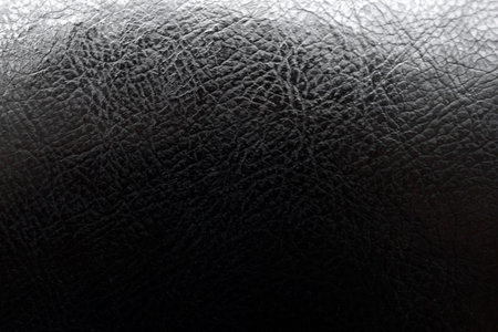 Black leather surface of the product close-up