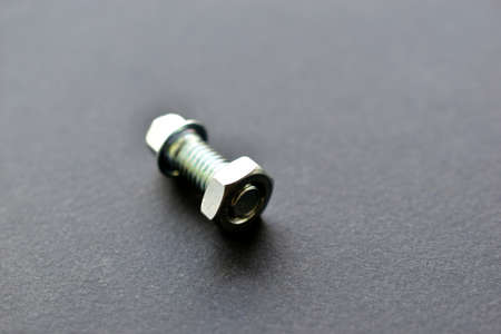 Silver bolt and nut on black backgroundの写真素材
