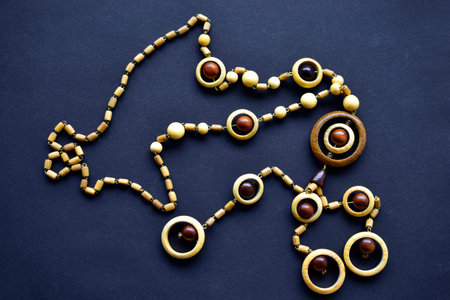Wooden beautiful round beads on black backgroundの写真素材