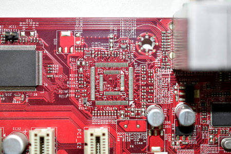 Red computer motherboard chip close-up with elements