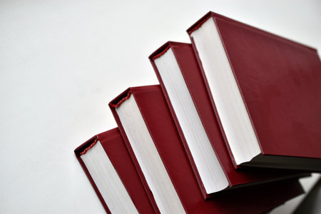Red bound books on a white backgroundの写真素材