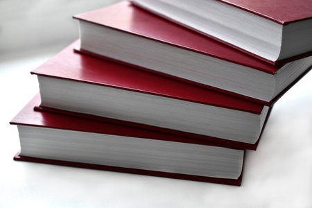 Red bound books on a white background