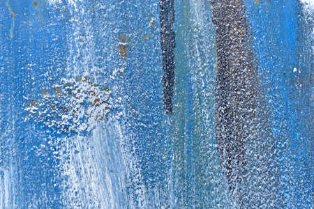 The metal surface painted with multicolored colors speckles and stripes is sloppyの写真素材