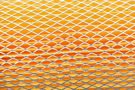 Orange car filter background with iron grille close-up