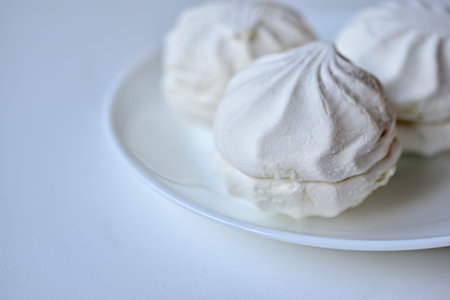 Colorful delicious marshmallows on a white plateの写真素材