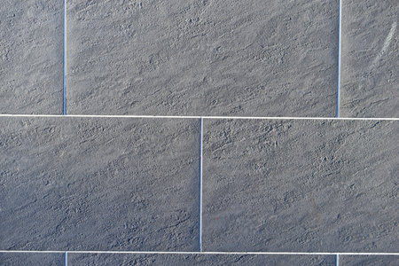 Gray ceramic tiles on the wall of the house