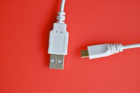 White USB PC cable on red backgroundの写真素材
