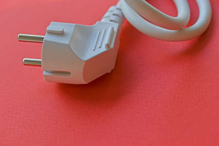 White electric euro plug on red backgroundの写真素材