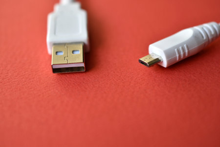 White USB PC cable on red background