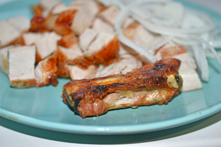Sliced pork with pickled onions on a plate