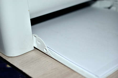 Black and white laser printer tray with paperの写真素材