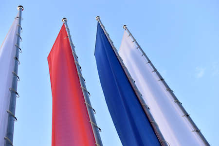 Tricolor flags on the square are red white and blueの写真素材
