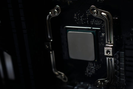 Silver computer processor on a black motherboard