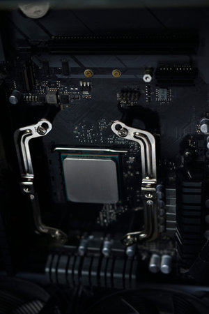 Silver computer processor on a black motherboard