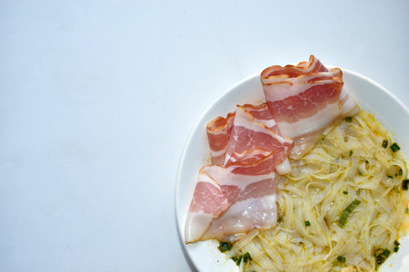 White plate with delicious noodle soup and seasonings