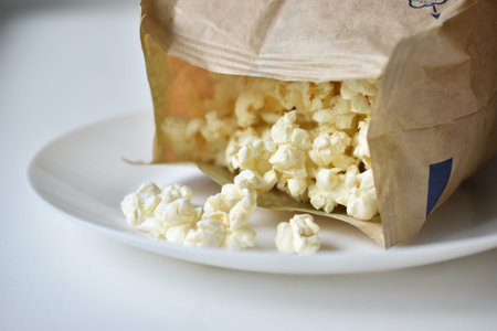 A bag of popcorn open on a plate in the kitchen