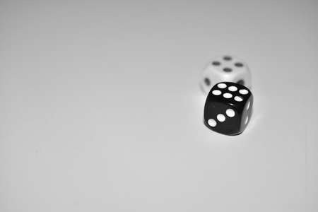 Dice in black and white on a white backgroundの写真素材