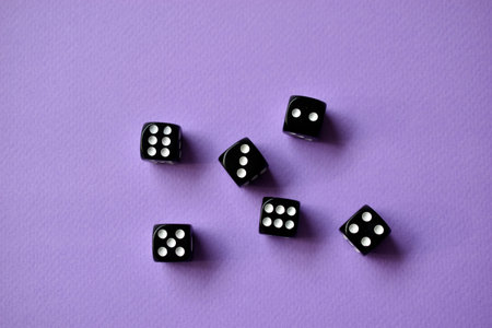 Dice are black and white on a purple backgroundの写真素材