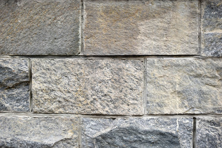 The wall is made of gray granite stone