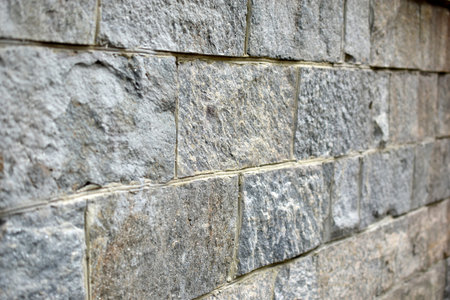The wall is made of gray granite stone