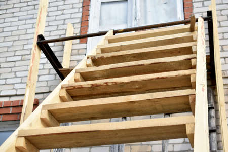 Wooden staircase at the garden house in flowersの写真素材