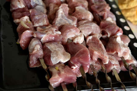 Raw pork meat on a barbecue skewerの写真素材