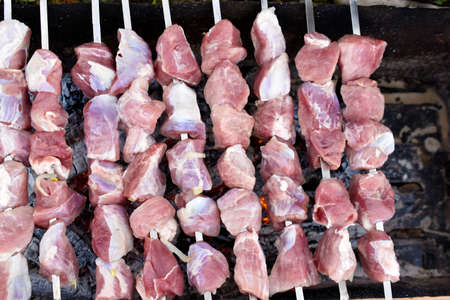 Raw pork meat on a barbecue skewerの写真素材