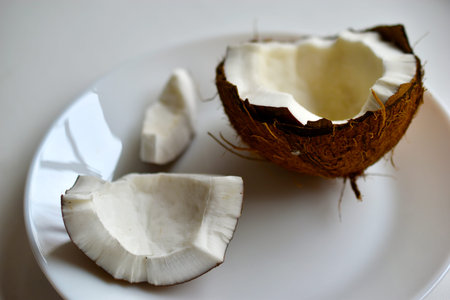 A broken slice of coconut on a plate