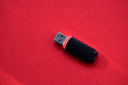 USB flash drive on a red velvet backgroundの写真素材