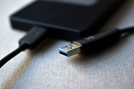 External hard drive with usb cable on a gray backgroundの写真素材