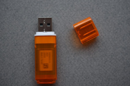 Orange usb flash card on gray background