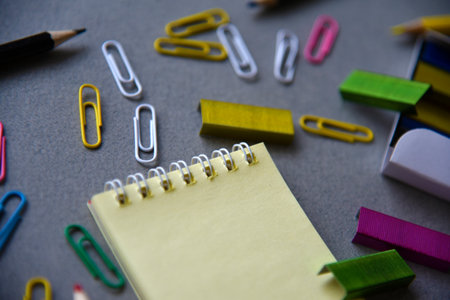 Pencils notepad and paper clips on the office deskの写真素材