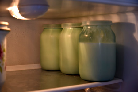 Glass jars with milk in the fridgeの写真素材