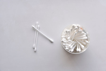 Cotton swabs in a jar on a white background